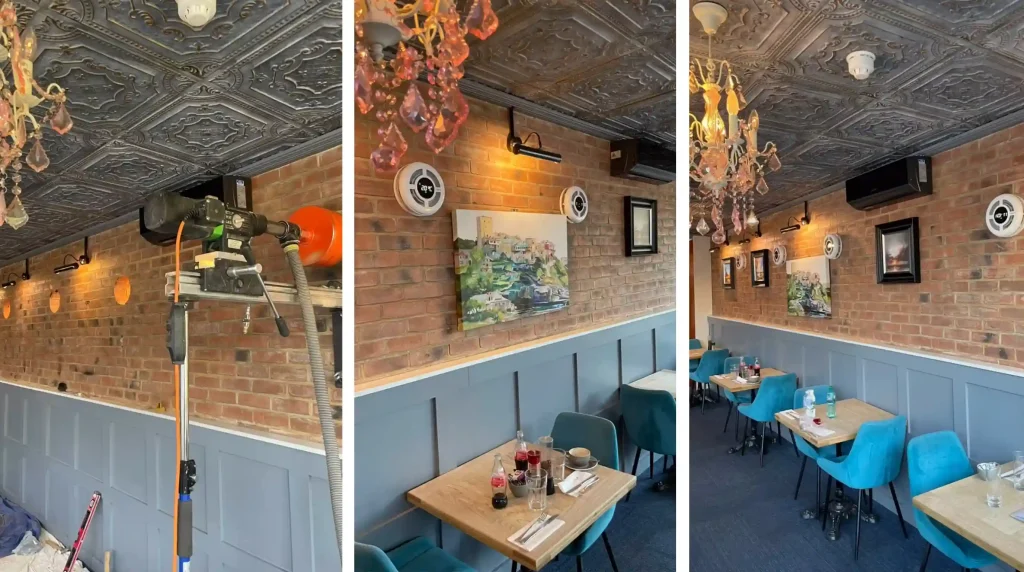 A stylish decentralised mechanical extract ventilation unit installed on a cafe's brick wall, providing discreet commercial ventilation